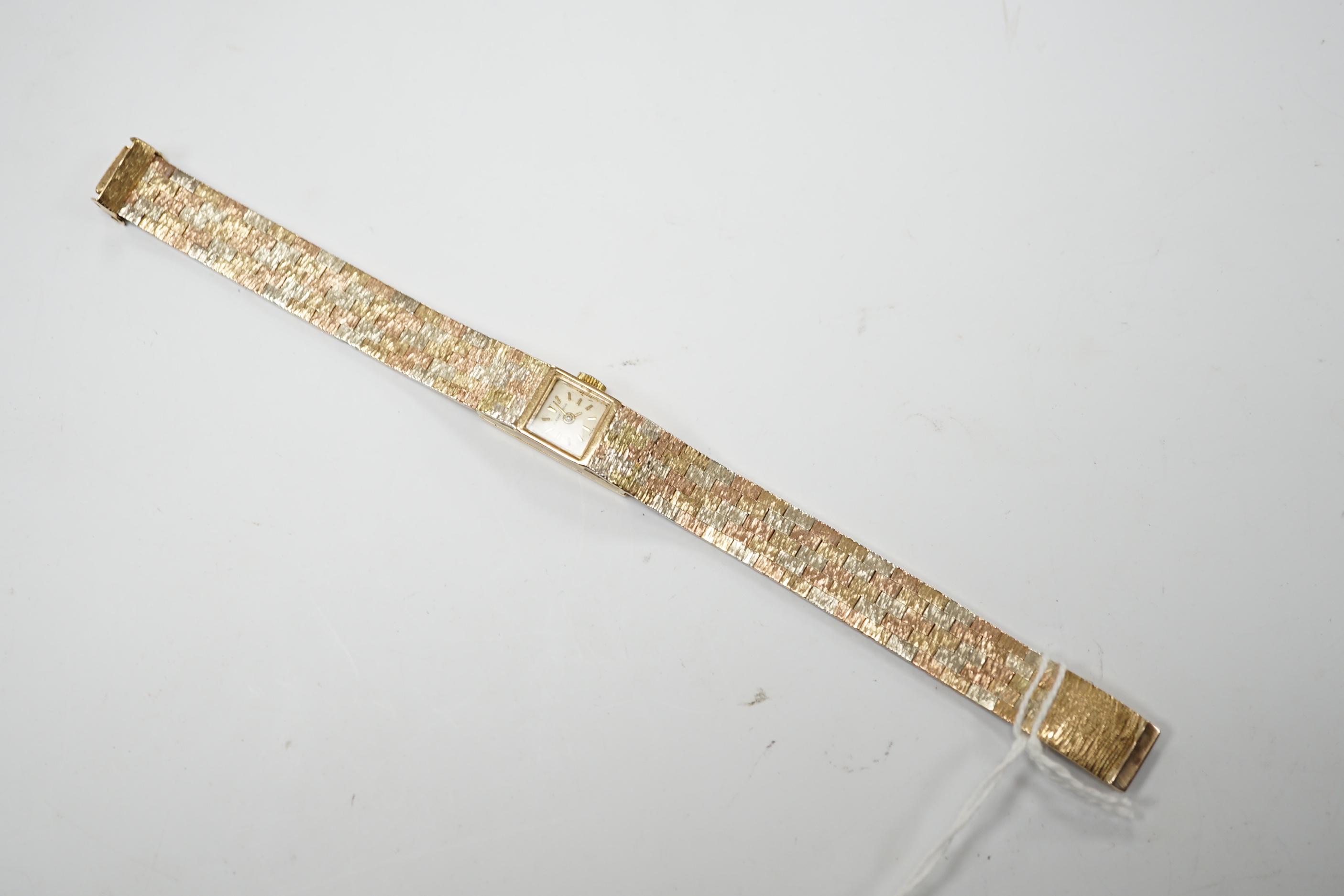 A lady's 9ct three colour gold Beuche Girod manual wind bracelet wrist watch, overall 16.7cm, gross weight 30.1 grams.